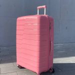 Чемодан Bizon Н03 розовый, вид спереди под углом (три четверти) с поднятой выдвижной ручкой